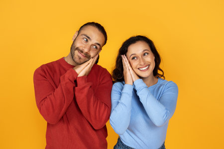 Happy young european man and woman showing sleeping gesture