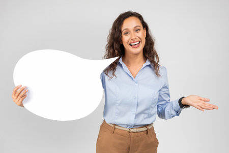 Positive caucasian young lady in formal wear hold abstract cloud for thoughts, textの写真素材