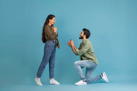 Happy indian man making his girlfriend marriage proposalの写真素材