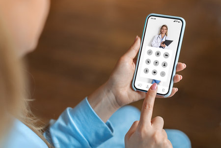 Young woman using medical app on smartphone at homeの写真素材