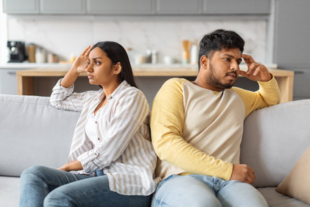 Young Offended Indian Couple Sitting Back To Back On Couch At Home