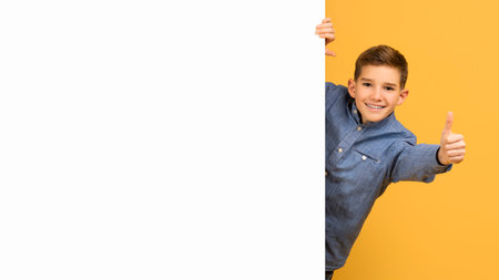 Teen Boy Standing Near Blank Advertisement Board And Showing Thumb Upの写真素材
