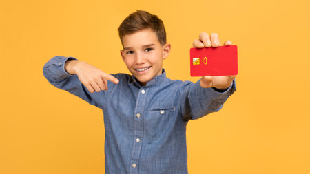 Great Bank. Happy Teen Boy Pointing At Credit Card In Hand