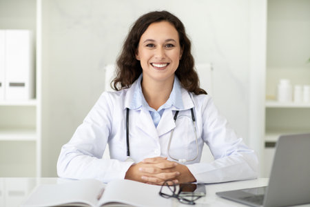 Portrait of beautiful millennial woman doctor sitting at her officeの写真素材