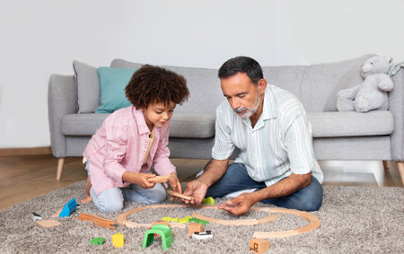 Senior grandpa and grandson kid boy playing games indoorの写真素材