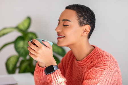 Contented young woman with a serene expression, savoring her coffee