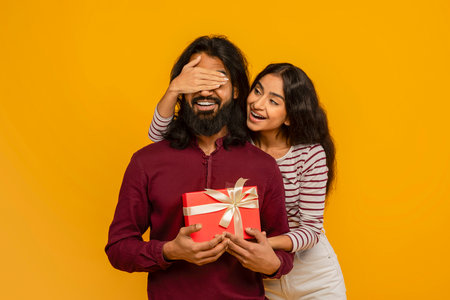 Loving young indian woman make surprise for her husbandの写真素材