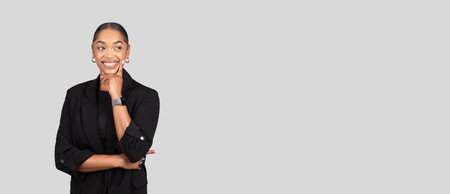 Happy pensive young african american woman in formal suit think, look at free spaceの写真素材