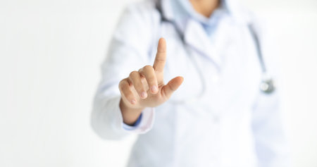 Unrecognizable woman doctor touching transparent screen, croppedの写真素材