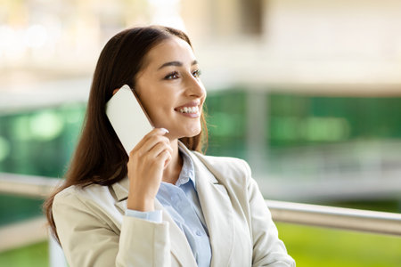 Content young businesswoman talking on her smartphoneの写真素材