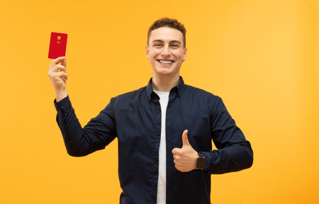 Happy guy hipster showing bank credit cardの写真素材