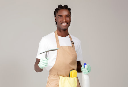 Cleaning Services. Handsome Black Cleaner Man Posing With Detergents And Washing Toolsの写真素材
