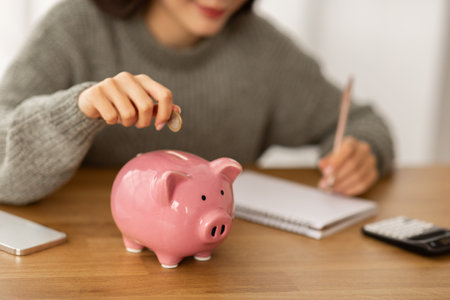 Cropped of woman working on month budgetの写真素材