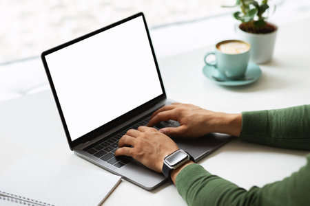 Cropped of man entrepreneur working at cafe, using computerの写真素材