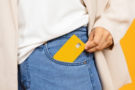 Hand of young asian lady puts credit card it in pocket, enjoy shoppingの写真素材