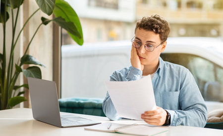 Sad tired confused millennial european guy student manager with laptop, work, study