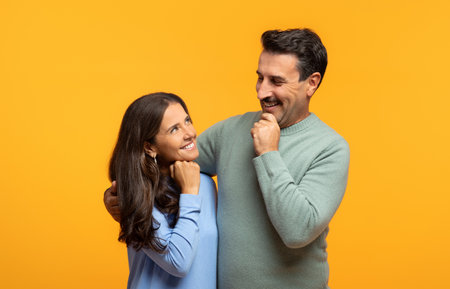 Pensive happy aged european wife and husband in casual hugs, thinks, enjoy date togetherの写真素材