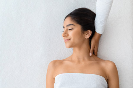 Top view of eastern woman receiving relaxing neck massageの写真素材