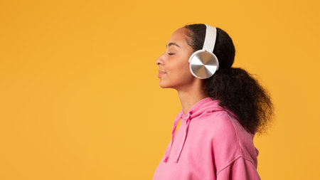 Side View Of African Teen Lady Wearing Wireless Headset, Studio