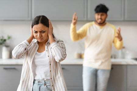 Young indian couple have fight at kitchenの写真素材