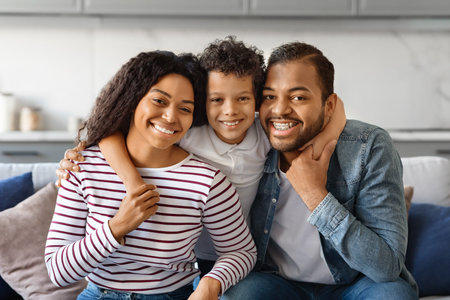 Happy Family Portrait. Smiling black parents and their little son posing togetherの写真素材