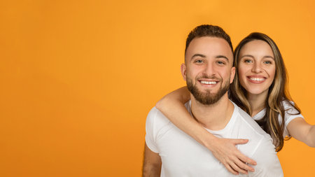 Happy young european guy holding woman on his back, have fun, enjoy spare time