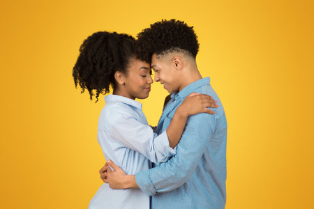 An intimate moment between two young individuals with eyes closed and heads touchingの写真素材