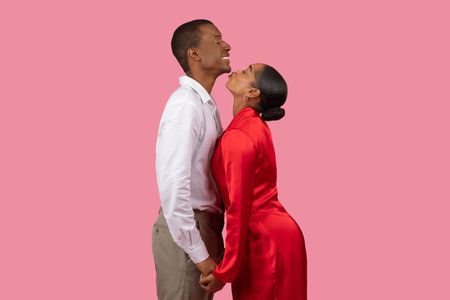 African american woman in red dress adoring man in white shirtの写真素材