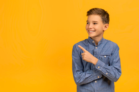 Check This. Smiling Teen Boy Pointing Aside At Copy Spaceの写真素材