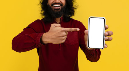 Cropped of eastern man pointing at phone in his handの写真素材