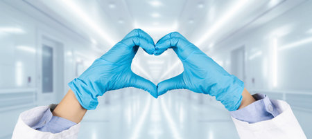 Gloved hands of a medical professional form a heart shape, expressing careの写真素材