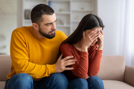 Loving Young Man Comforting His Upset Girlfriend At Home