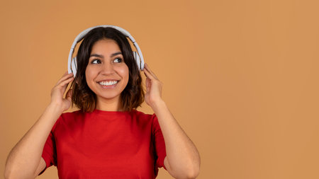 Middle eastern woman with wireless headphones, copy spaceの写真素材