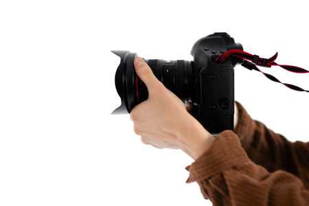 Close-up of male hands holding professional camera