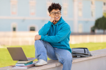 student guy with wireless earbuds listening to online lecture outdoor