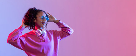 Happy woman enjoying music with headphones and sunglasses, copy spaceの写真素材