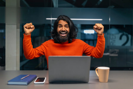 Man excited with computer in officeの写真素材