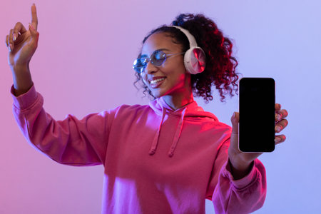 Happy lady dancing with phone and headphonesの写真素材
