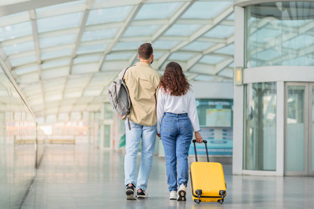 Travelling Together. Rear View Of Young Couple Waiting For Flight At Airportの写真素材