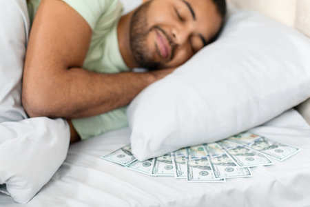 Cash scattered on bed signifies financial conceptの写真素材