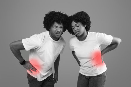 African america man and woman in pain touching abdominal side