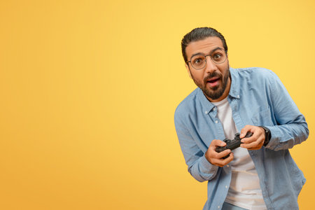 Man surprised playing with game controllerの写真素材