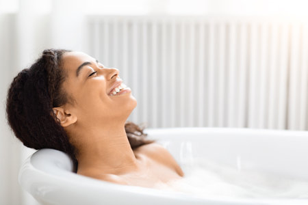 Woman relaxing in a bubble bath and smiling