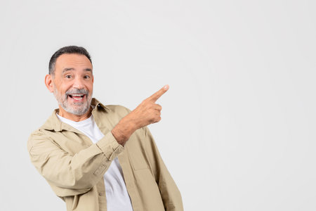 Smiling man pointing to the side, blank spaceの写真素材