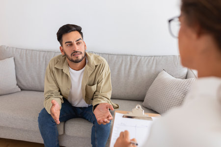 Middle eastern man speaking with therapist on couch