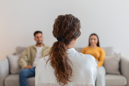 Therapist seen from behind viewing a coupleの写真素材