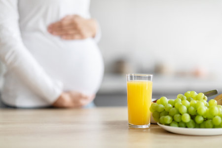 Pregnant woman with healthy food in kitchenの写真素材