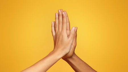 Man and woman greeting each other with high fiveの写真素材