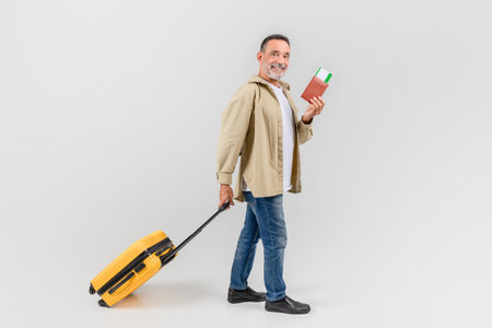 Man with suitcase and passport ready to travelの写真素材