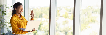 Excited african american woman entrepreneur having video call on laptopの写真素材